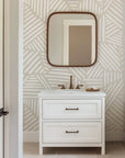 Pale tan wallpaper featuring a continuous motif of sketched geometric shapes, drawn with white linear strokes