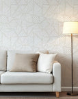 Wall covering design in neutral beige, displaying repeating white geometric blocks created from linear brushwork
