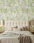 Lavender Garden floral wallpaper with purple blooms and green foliage on cream bedroom accent wall