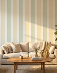 Green and mustard vertical stripe removable wallpaper in modern living room with cream sofa