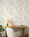 Lemon Grove removable wallpaper with yellow florals and sage leaves on cream background in modern home office