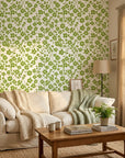 Green botanical Lime Bloom wallpaper with clover pattern on cream background in modern living room