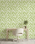 Lime Bloom botanical wallpaper with green clover pattern on cream background in modern home office setting