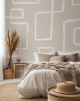 Neutral beige wallpaper with abstract hand drawn white line rectangles arranged in an organic geometric pattern.