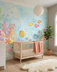 Watercolor ocean scene Little Blue World wallpaper in pastel nursery with coral, fish, and bubbles