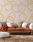 Self-adhesive wallpaper featuring the Loop Dreams design in soft pink and yellow abstract loops