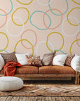 Self-adhesive wallpaper featuring the Loop Dreams design in soft pink and yellow abstract loops