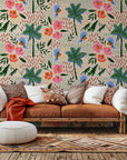 Peach-colored tropical wall covering featuring parrots, palm fronds, and hibiscus blooms.