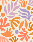 Playful abstract botanical wallpaper with hand painted leaf and floral shapes in peach, lavender, ochre, and soft coral on a warm cream background.