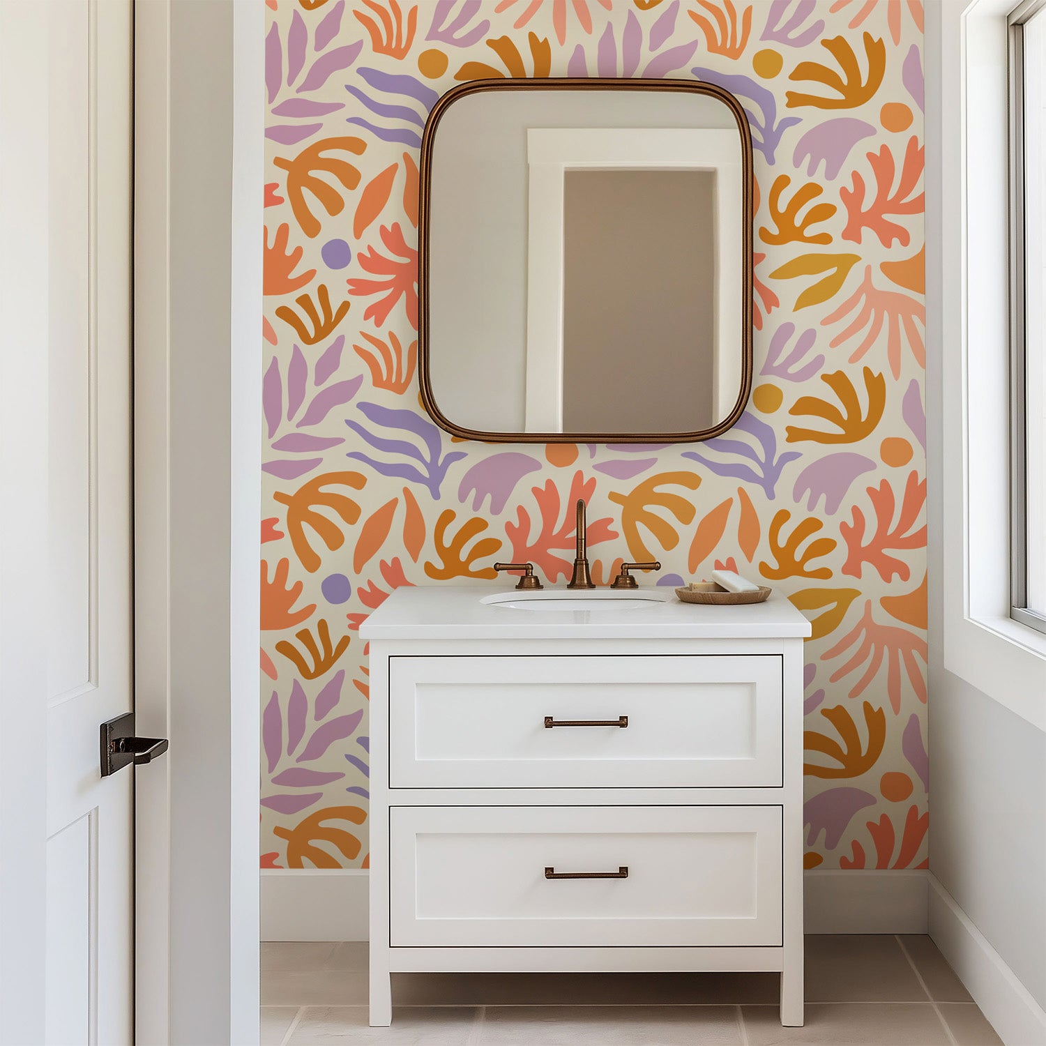 Playful abstract botanical wallpaper with hand painted leaf and floral shapes in peach, lavender, ochre, and soft coral on a warm cream background.