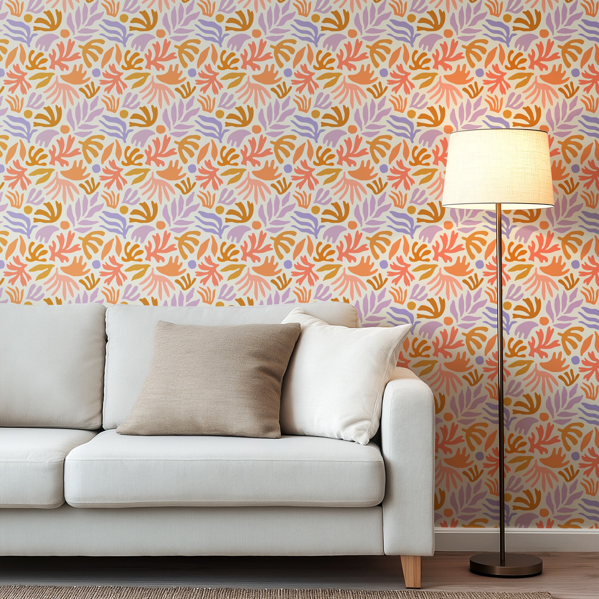 Playful abstract botanical wallpaper with hand painted leaf and floral shapes in peach, lavender, ochre, and soft coral on a warm cream background.