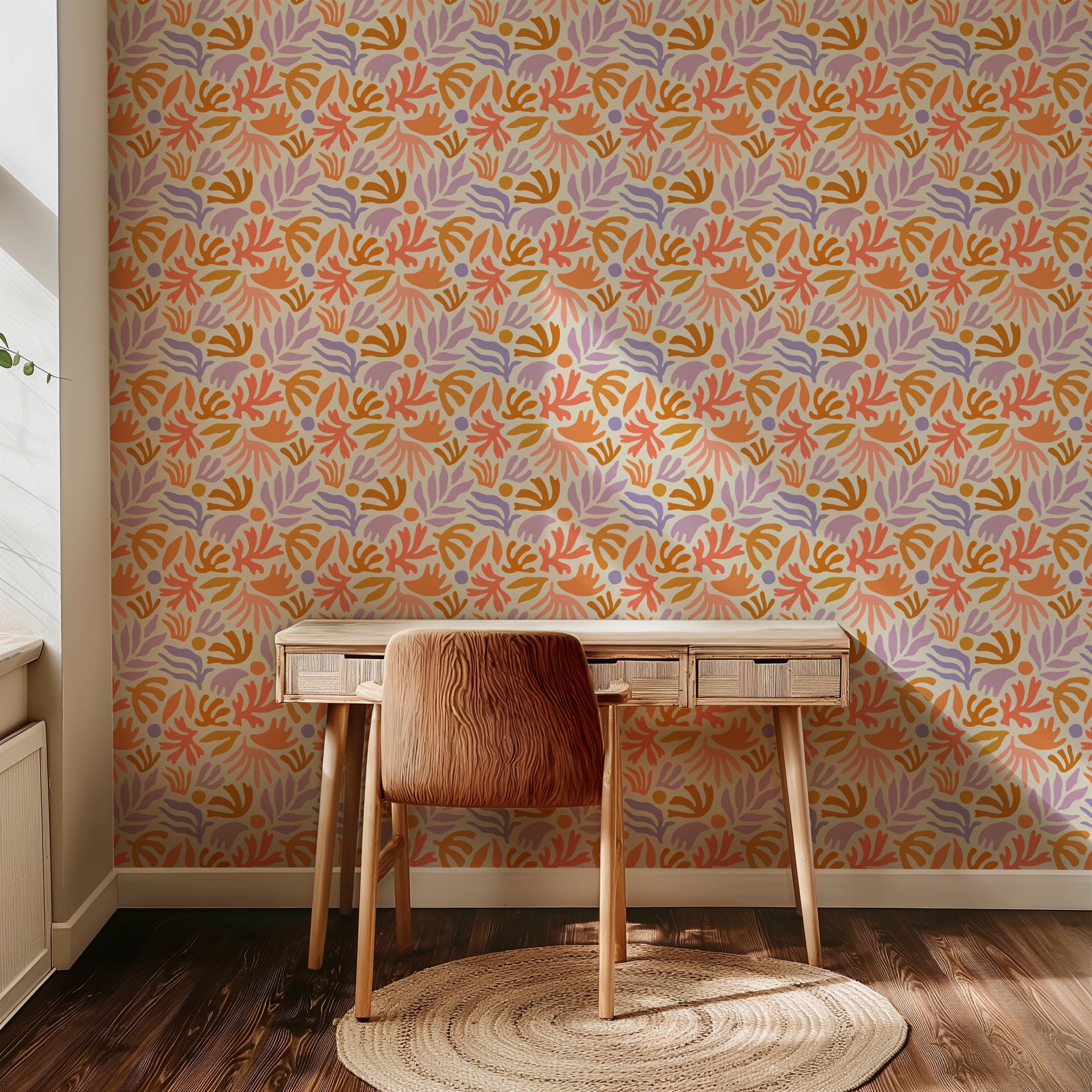 Playful abstract botanical wallpaper with hand painted leaf and floral shapes in peach, lavender, ochre, and soft coral on a warm cream background.