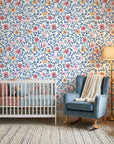 Matisse Reverie removable wallpaper with blue floral vines and coral blooms in modern nursery setting