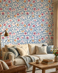 Matisse Reverie removable wallpaper with blue vines and coral flowers on cream living room accent wall
