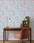 Coral, pink, and gold floral Matisse Reverie peel and stick wallpaper in modern home office setting