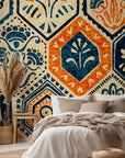 Vintage hexagon tile wallpaper with hand printed floral motifs in navy blue, warm orange, and cream tones.