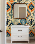 Vintage hexagon tile wallpaper with hand printed floral motifs in navy blue, warm orange, and cream tones.