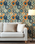 Vintage hexagon tile wallpaper with hand printed floral motifs in navy blue, warm orange, and cream tones.