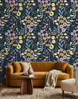 Midnight Bouquet removable wallpaper on living room wall with yellow daisies and pink florals on navy background