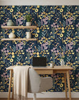 Navy blue Midnight Bouquet peel and stick wallpaper with yellow daisies and pink flowers in home office setting