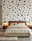 Midnight Dust white with black star pattern wallpaper adding character to a cozy bedroom