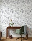 Midnight Fossil removable wallpaper with black botanical leaf sketches on linen-textured cream background in home office