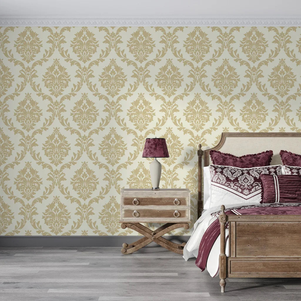 Gold damask Misty Fern Romance wallpaper on cream background in elegant bedroom setting