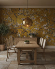 Monet's Garden wallpaper with golden yellow background and white cherry blossoms in elegant dining room
