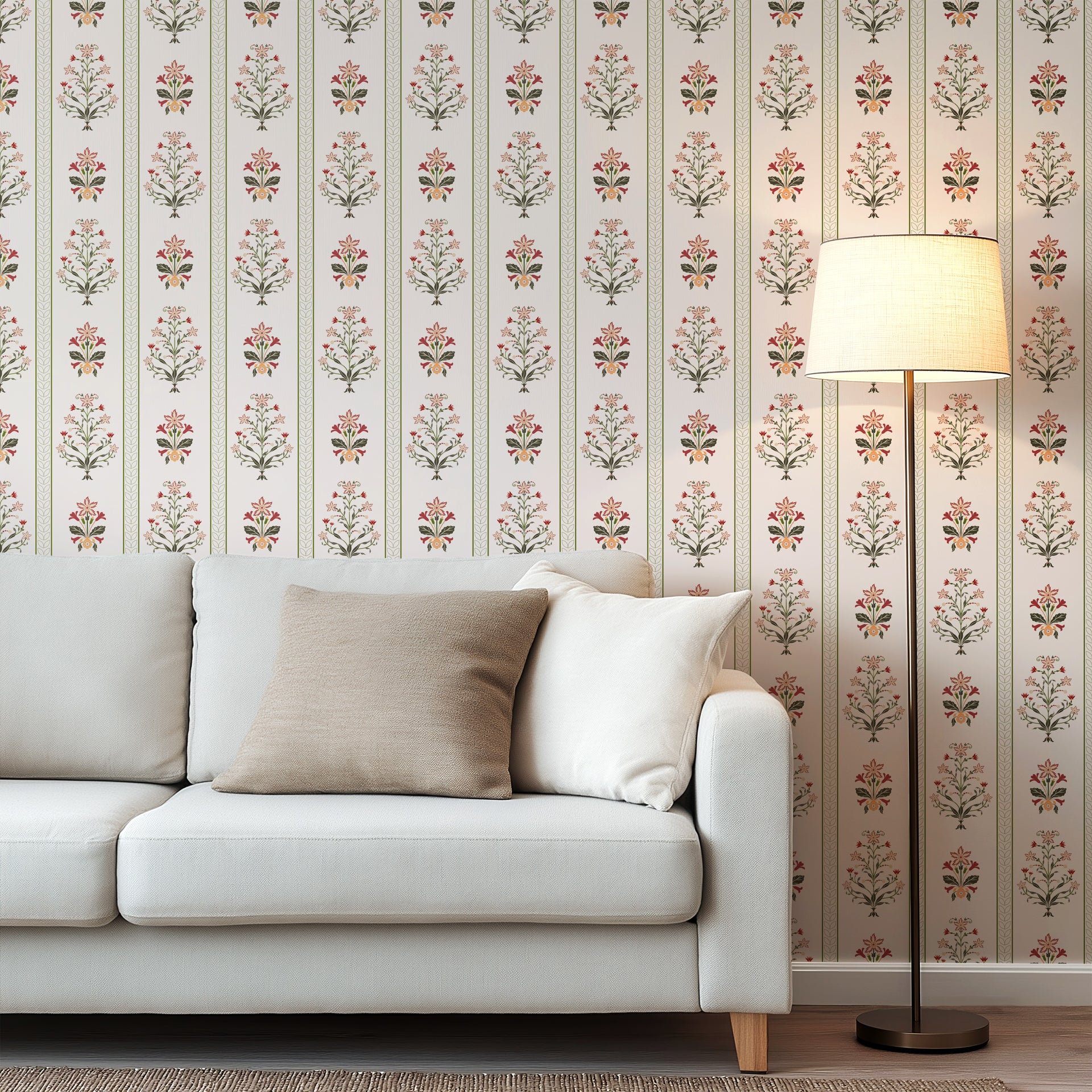 Vertical floral stripe wallpaper with symmetrical folk inspired flowers in red, olive green, and soft peach on a warm cream background.