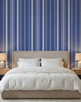 Nautical Code blue and white striped wallpaper adding character to a cozy bedroom