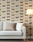 Playful leopard wallpaper with hand illustrated spotted cats in tan, caramel, and black on a soft beige background.