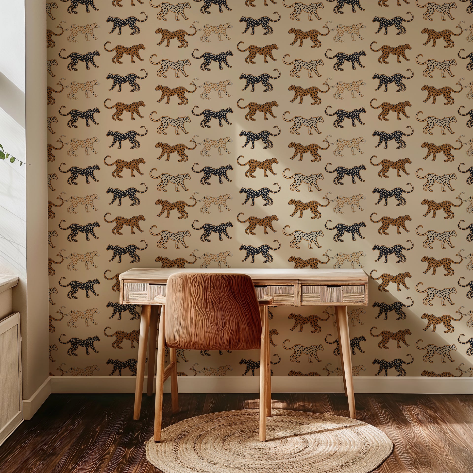 Playful leopard wallpaper with hand illustrated spotted cats in tan, caramel, and black on a soft beige background.