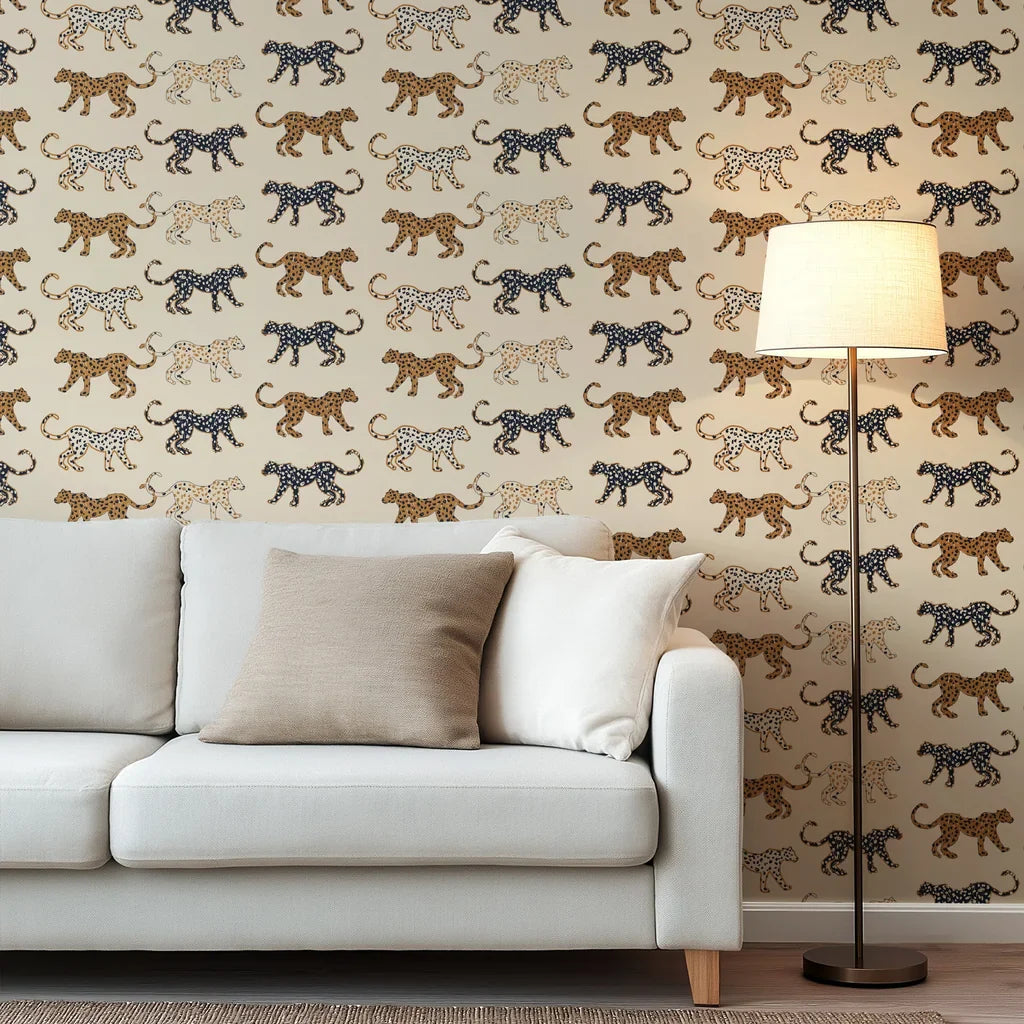 Wallpaper with playful, hand-sketched spotted cats in tan, black, and warm caramel tones, all superimposed on a soft beige backdrop.