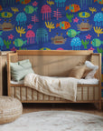 A whimsical blue wallpaper displaying brightly colored, cutout-style ocean life
