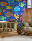 A cheerful blue wall decoration with die-cut style representations of multi-hued ocean life