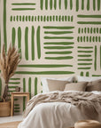 Olive green abstract wallpaper with hand drawn brush stroke blocks arranged in a loose geometric grid on a warm cream background.