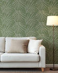 Olive green abstract wallpaper with scattered white speckled brush strokes forming an energetic, organic pattern.