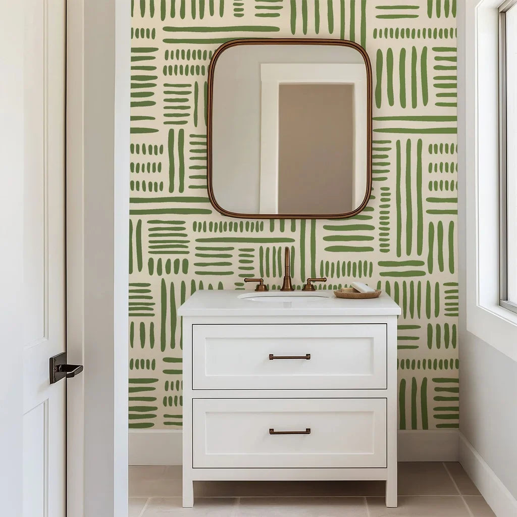 Hand-drawn blocks of olive green paint are laid out in an open, geometric grid structure on an abstract wall design with a warm, off-white background.