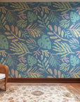 Serene blue wall covering displaying hand-drawn, chalk-effect tropical foliage in light, pastel colors.