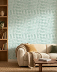 Pale Dawn serene green plaid wallpaper in a warm and inviting living room