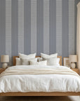 Parlor Stripe blue geometric peel and stick wallpaper adding character to a cozy bedroom