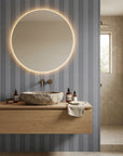 Parlor Stripe blue geometric peel and stick wallpaper creating ambiance in a serene bathroom