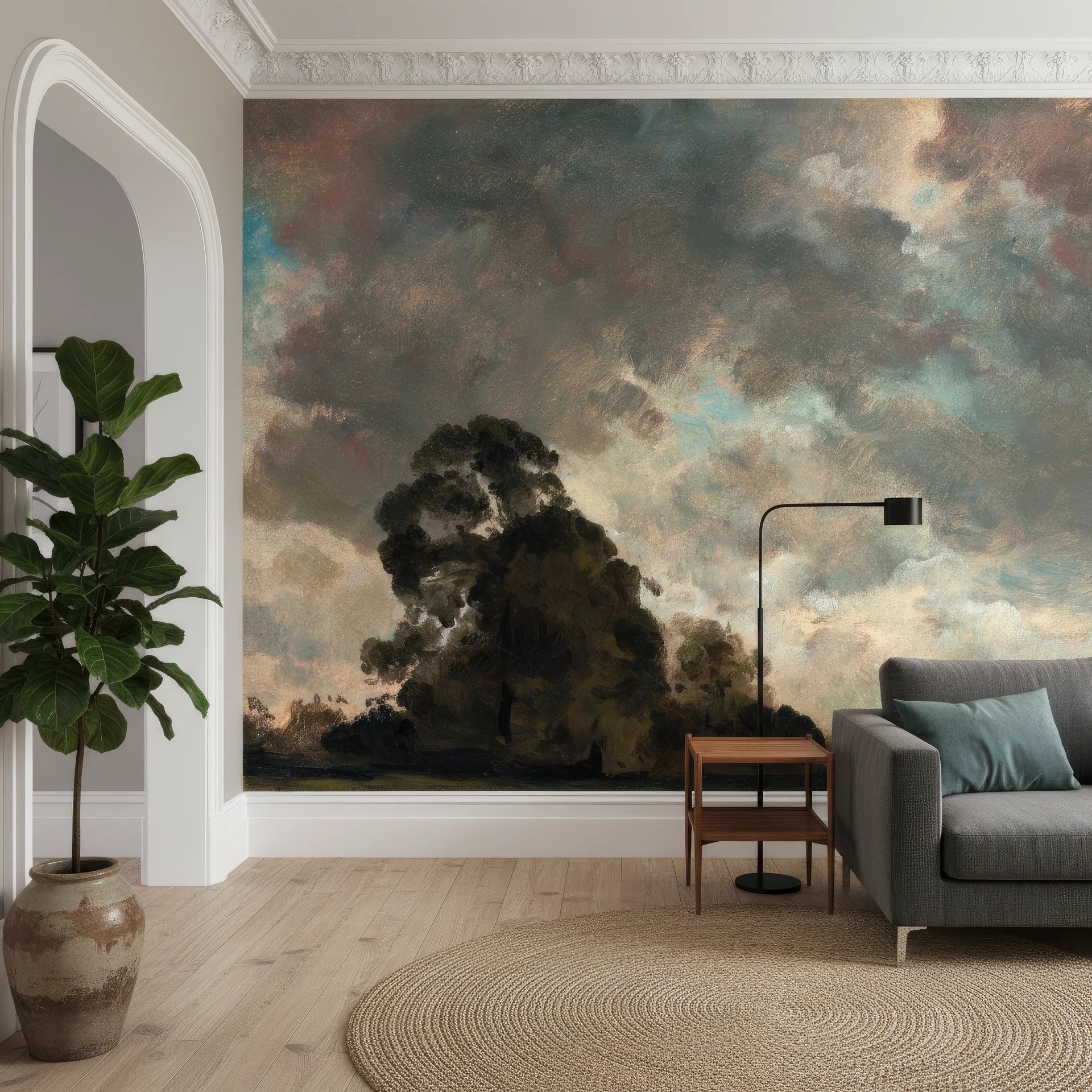 Dramatic painterly landscape wallpaper with stormy skies and dark trees on modern living room accent wall