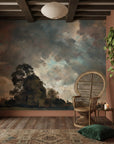 Pastoral Meadow mural wallpaper featuring dramatic sky and ancient trees in a modern rustic living room