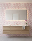 Petal Drift blush pink cherry blossom wallpaper creating ambiance in a serene bathroom