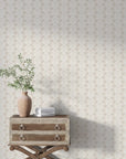 Beige and white Petal Symphony damask wallpaper in elegant room with vintage dresser and greenery