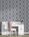 Blue and beige Poet's Blossom damask wallpaper behind elegant white vanity desk with pink tufted chair