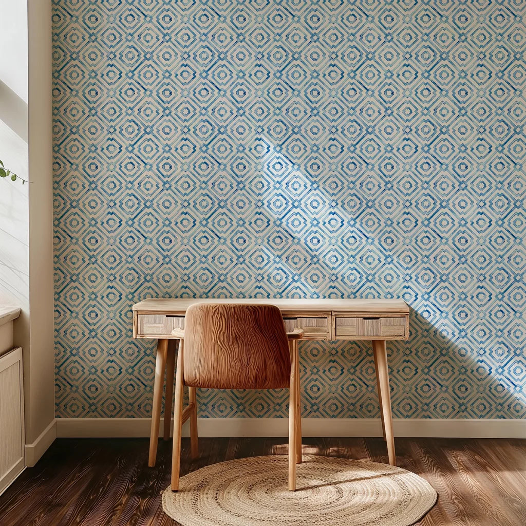 This blue geometric wallpaper uses hand-painted watercolor shapes in a porcelain style to construct a repeating diamond lattice pattern atop a white base