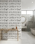 Pressed Botanicals black and white wildflower wallpaper creating ambiance in a serene bathroom