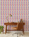 Prism Weave colorful geometric peel and stick wallpaper as a feature wall in a bright home office